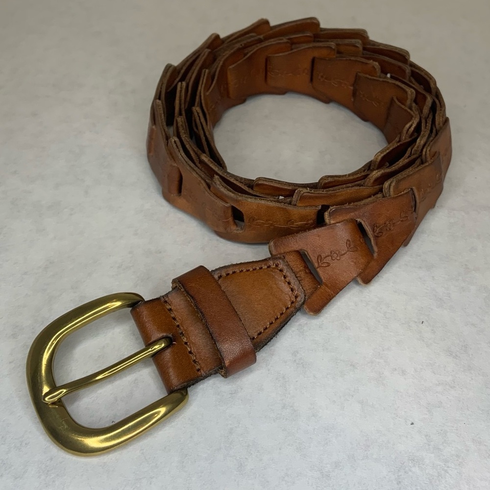 Vintage brown leather belt with embossed floral design and gold tone buckle
